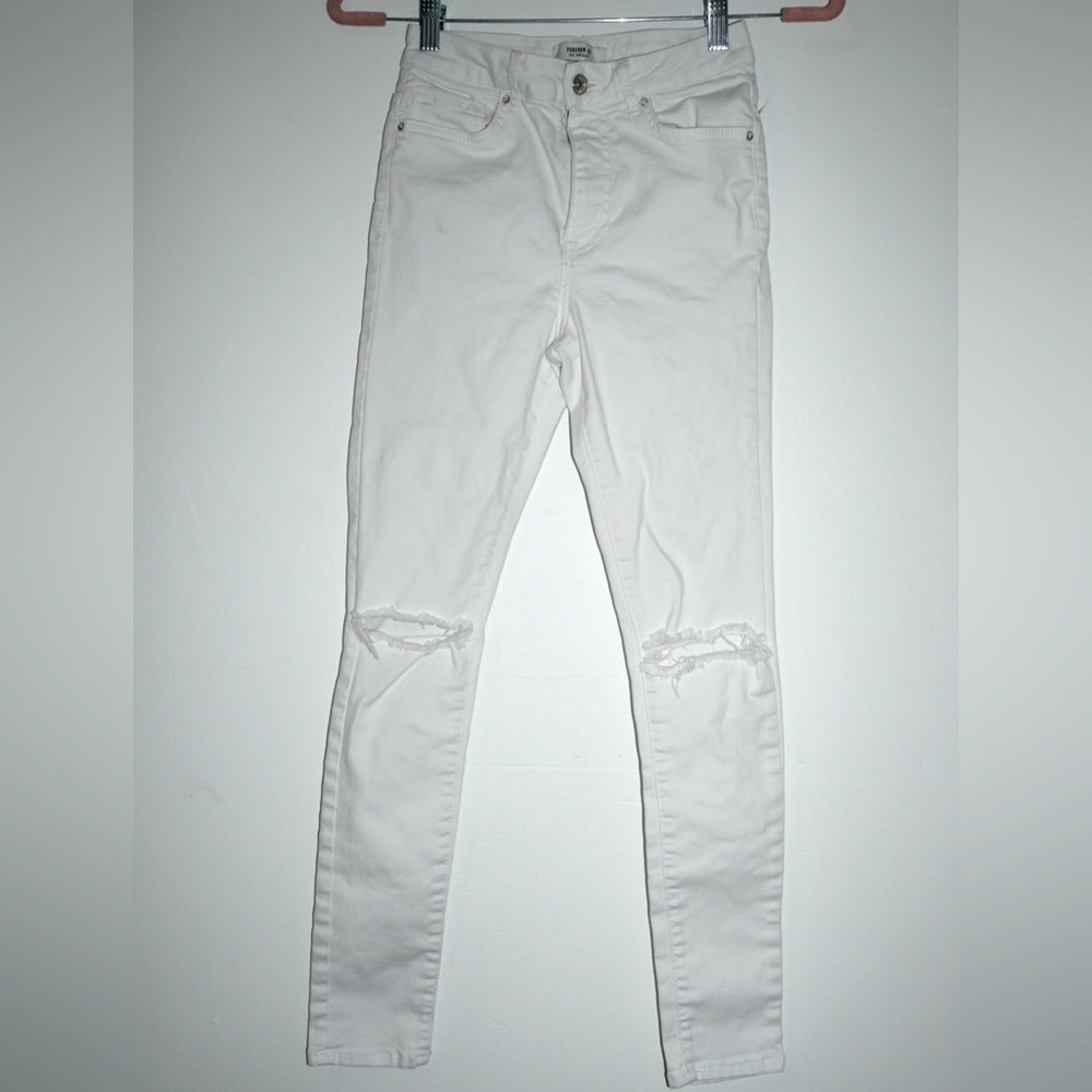 Forever 21 High waisted white jeans with rips in the knees. Stretchy. Size 24.